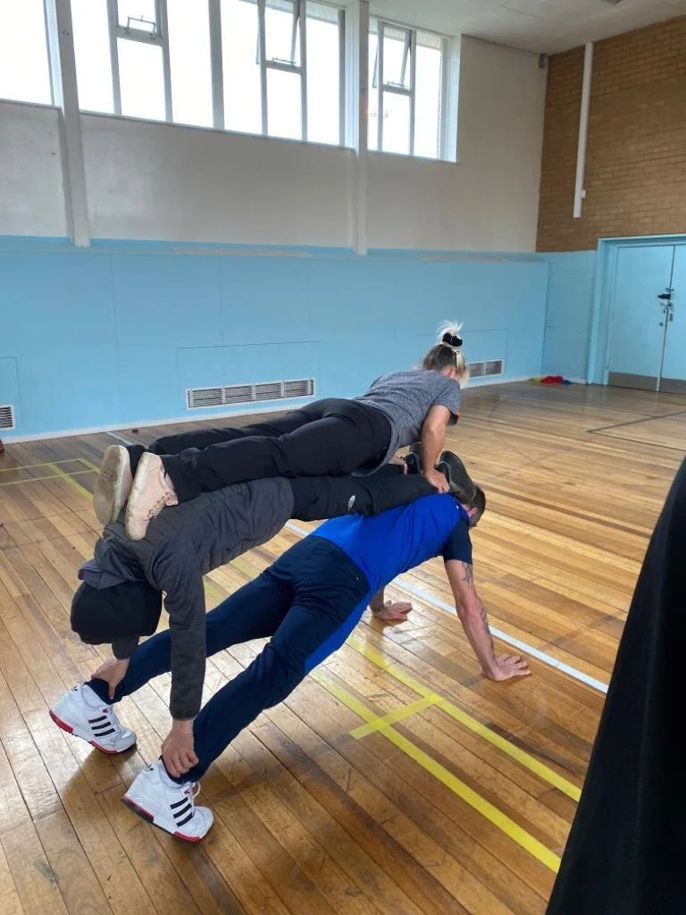 Primary school pupils doing partner yoga and balance work in Atherton
