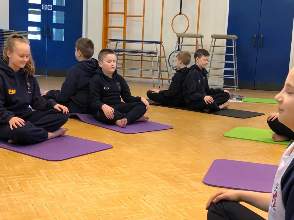 Children practising yoga and mindful movement in an Atherton primary school