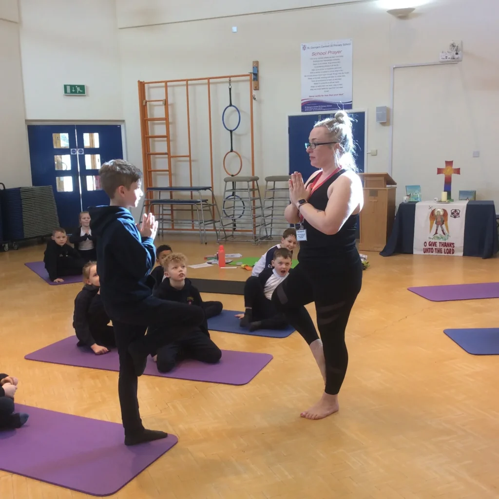 Students practising fun yoga poses to build confidence and coordination in school