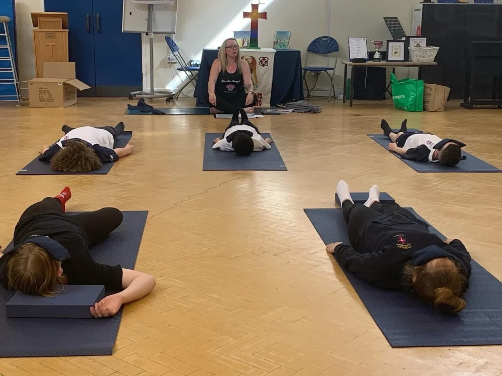 Primary school pupils practising mindful movement and balance activities during a yoga session in Bolton